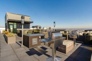 a rooftop patio with a grill on top of a building at Blackout Curtainsking Bedin-suite Wdbalcony in Tacoma