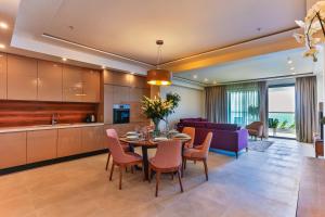 a kitchen and dining room with a table and chairs at Sunraf Luxe Apartments in Budva