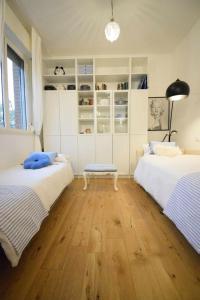 a bedroom with two beds and a bench in it at Piccolo Angolo in Città in Castenaso +44 photos
