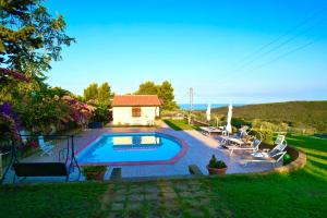 a swimming pool in the yard of a house at Villa Toscagialla in San Vincenzo