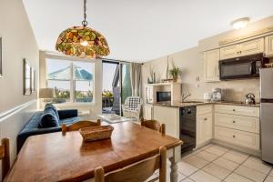 a kitchen and dining room with a wooden table in a kitchen at The Surf Club Resort in Montauk