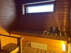 a room with a sauna with a pot on a shelf at Star of Annala in Tampere