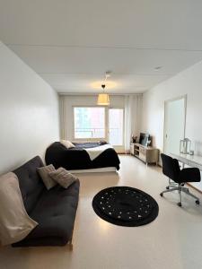 a large bedroom with a bed and a couch at Star of Annala in Tampere