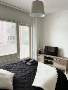 a bedroom with a bed and a large window at Star of Annala in Tampere