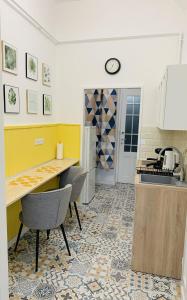 a kitchen with a counter and chairs in a room at Margaret Boulevard Apartment - with balcony in Budapest