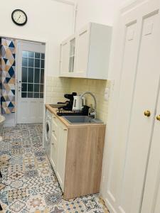 a kitchen with a sink and a washing machine at Margaret Boulevard Apartment - with balcony in Budapest +10 photos