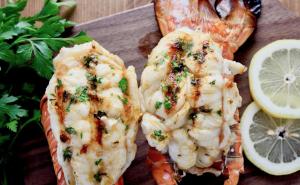 two pieces of shrimp and a lemon on a cutting board at Kundmalir Gold Coast Beach Resort 