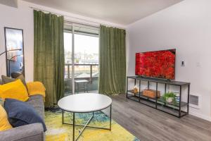 a living room with a couch and a tv at Downtown-smart Tv-king Bed-self Check-in-balcony in Tacoma