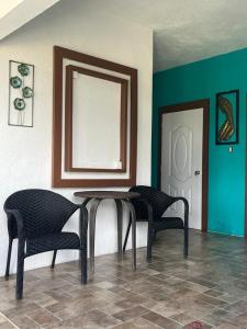 a table and two chairs in a room at SerenitHe in Negril