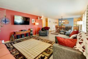 a living room with red walls and a flat screen tv at Single-Story Soldotna Home Near the Kenai River! in Soldotna