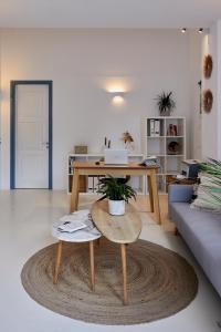 a living room with a table and a couch at Athiri Santorini Hotel in Imerovigli