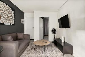 a living room with a couch and a table at Marley on Katherine Apartments in Johannesburg