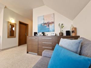 a living room with a couch and a dresser at Hotel 77 Restauracja Spa in Chałupy