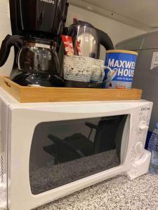 a microwave with a coffee pot on top of it at استديو بتصميم أنيق ودخول ذاتي in Riyadh