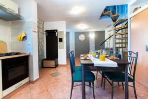 a kitchen and dining room with a table and chairs at House Poljica with a pool in Poljica