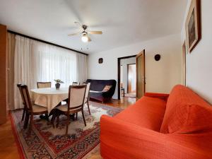 a living room with a red couch and a table at Apartments Marija in Selce