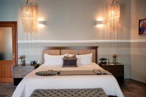 a bedroom with a large bed and two night stands at Casa Lucila Hotel Boutique in Mazatlán