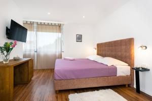 Ein Bett oder Betten in einem Zimmer der Unterkunft Villa NIKA
