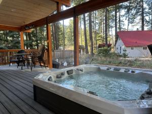 a hot tub on the deck of a house at Compass Cabin by NW Comfy Cabins in Leavenworth
