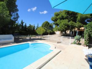 a swimming pool in a yard with an umbrella at Casa cerca del mar con piscina privada, aire opcional, wifi gratuito, mascotas y playas para perros - ES-184-60 in L'Ametlla de Mar
