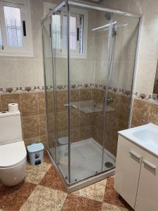 a bathroom with a shower with a toilet and a sink at El Gengo Suite in Madrid