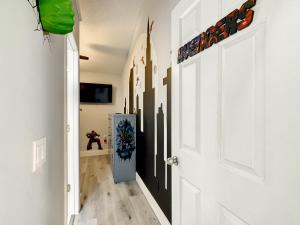 a hallway with white walls and a white door at Casita mi Encanto a Cozy & Spacious House, 4-bedroom 3-Bath & pool in Kissimmee