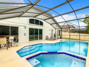 a swimming pool with a glass roof at Casita mi Encanto a Cozy & Spacious House, 4-bedroom 3-Bath & pool in Kissimmee