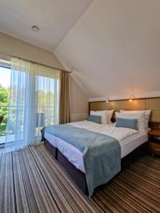 Postel nebo postele na pokoji v ubytování Hotel 77 Restauracja Spa