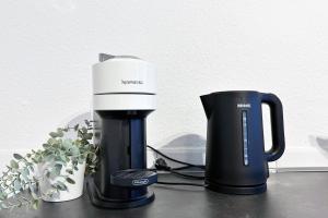 a coffee maker and a cup on a table at City Apartment in Krefeld in Krefeld