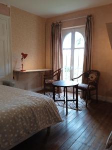 a bedroom with a bed and a table and a window at chambre chez l'habitant, axe A62, à 20 min d' ouest d'Agen, parking dans la rue gratuit, accès cuisine, convivial in Port-Sainte-Marie