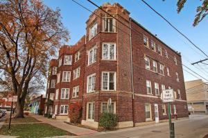 a large brick building on the corner of a street at Cozy Chic 1BR Chicago Apartment - Hartrey G in Evanston
