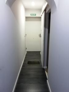 a hallway with a door with a sign on it at Centro Castillo 9 in Cáceres