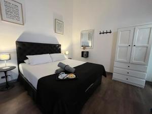 a bedroom with a bed with a tray of food on it at PH Palermo Hostel in Buenos Aires