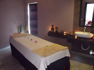 a bathroom with a bed and a sink at MEN's Resort & Spa (Gay Hotel) in Siem Reap