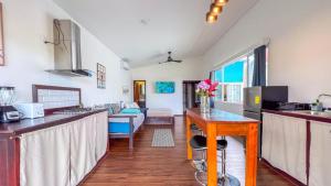 a kitchen and living room with a couch and a table at Chango's Apartments in Bocas Town