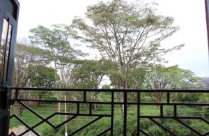 uma vista para um campo a partir de uma varanda em GP homes em Nyeri