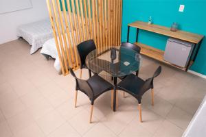 une table en verre et quatre chaises dans une pièce dans l'établissement Alta Pinta, à Paso de los Libres