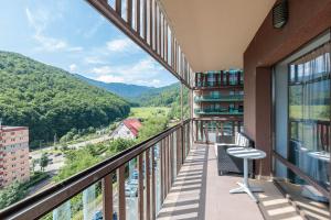 a balcony with a view of the mountains at Tampa Gardens Zen Apartment - Adults Only in Braşov