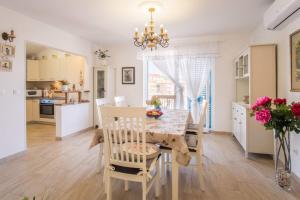 a kitchen and dining room with a table and chairs at Romantic stone villa with pool, panoramic sea view near the beach - by Traveler tourist agency Krk ID 2134 in Vrbnik