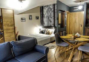 a bedroom with a bed and a table and chairs at Borovets Dream Studio in Borovets