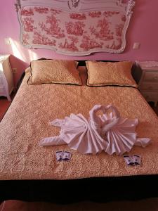 a woman in a dress is laying on a bed at LOS MIRLOS in Navaluenga