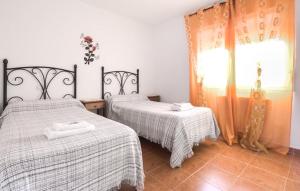 a bedroom with two beds and a window at LOS MIRLOS in Navaluenga