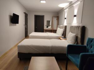 a hotel room with two beds and a couch at Olen Uskudar Hotel in Istanbul