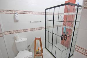 a bathroom with a toilet and a glass shower stall at Ozkan Apartment - Fethiye Center Fully Furnished 50Mbps Wifi Netflix in Fethiye