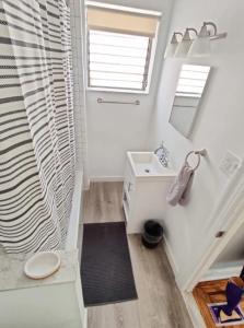 a bathroom with a sink and a toilet and a window at Cozy 1BDR In Center City Philly Hosted By StayRafa in Philadelphia