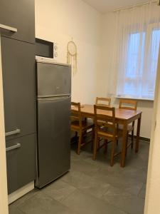 a kitchen with a dining table and a refrigerator at Rising Berlin in Berlin