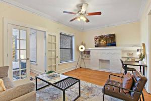 a living room with a ceiling fan and a fireplace at Cozy and Inviting Two-Bedroom Apartment - Sunnyside 3F in Chicago