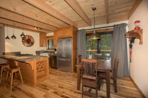 a kitchen with wooden floors and a table with chairs at Allenby- LuxuryCabin w Cozy Fireplace, Near Northstar! in Tahoe Vista