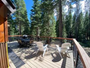 a deck with two chairs and a table and a grill at Allenby- LuxuryCabin w Cozy Fireplace, Near Northstar! in Tahoe Vista