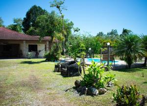 une cour avec une maison et une piscine dans l'établissement Casa a 5 min do Balneario Coroados - Guaratuba PR, à Guaratuba